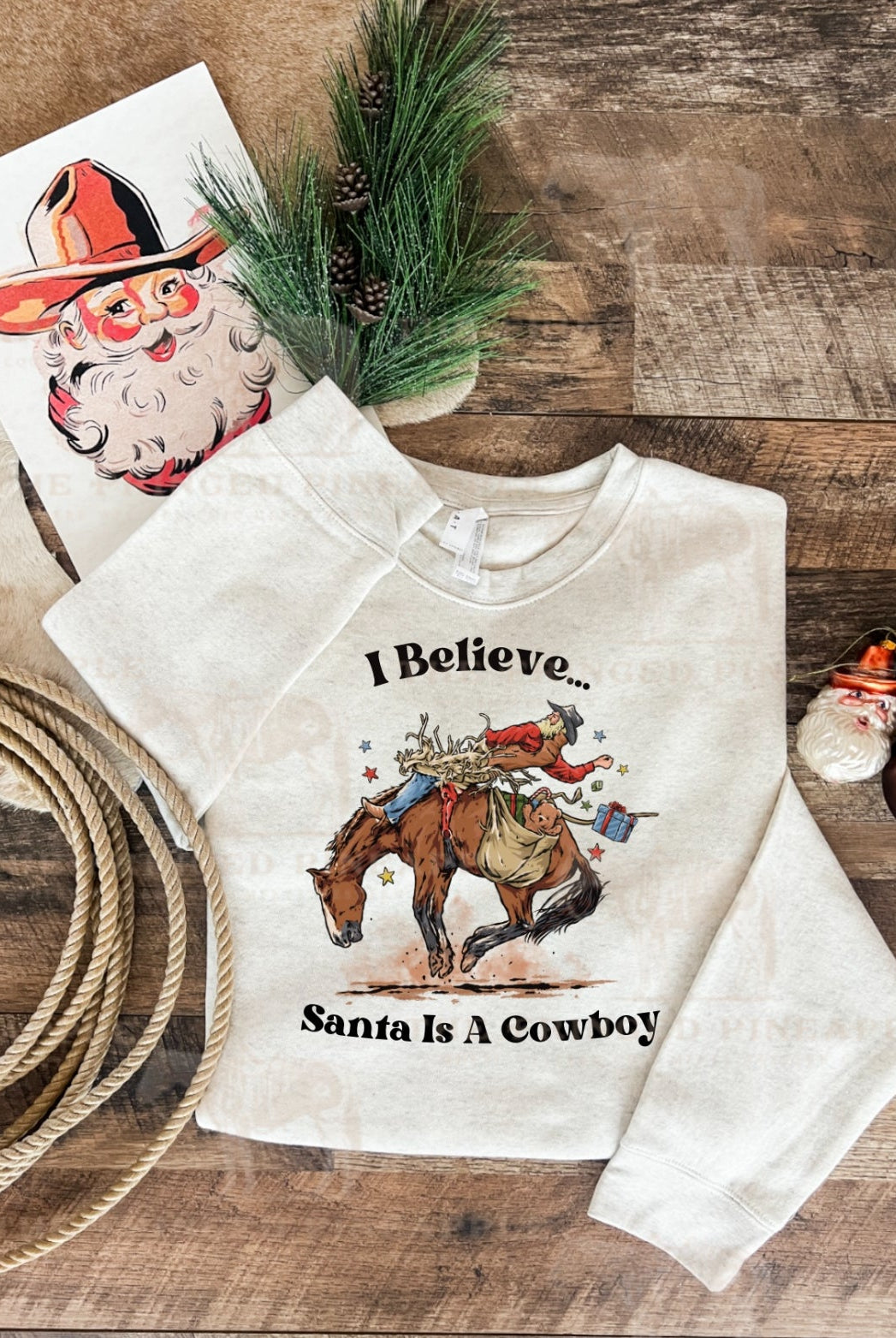 I Believe Santa Is A Cowboy Tee or Sweatshirt (Heathered Cream/Cream)