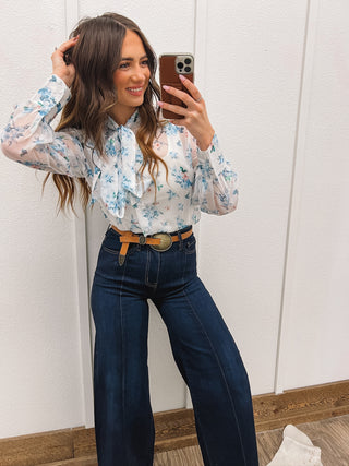 Model using a Blue Dream Baby Floral Front Tie Blouse
