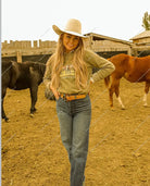 Model smiling with a Saddle Up or Go Sit In Truck Sweatshirt or Tee(green)